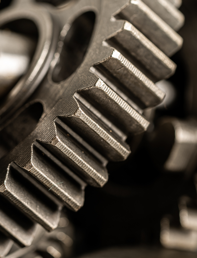 Close-up of a large, metallic gear showing detailed teeth structure.