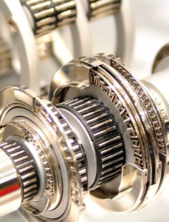 Close-up view of intricate metallic gears and bearings within a mechanical assembly.